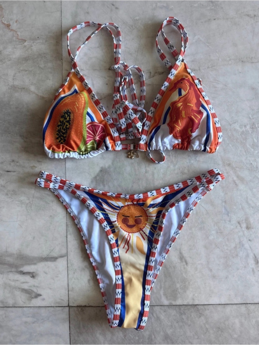 Orange, blue, and white bikini with sun graphic and geometric border